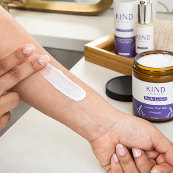 women smearing lotion on arm