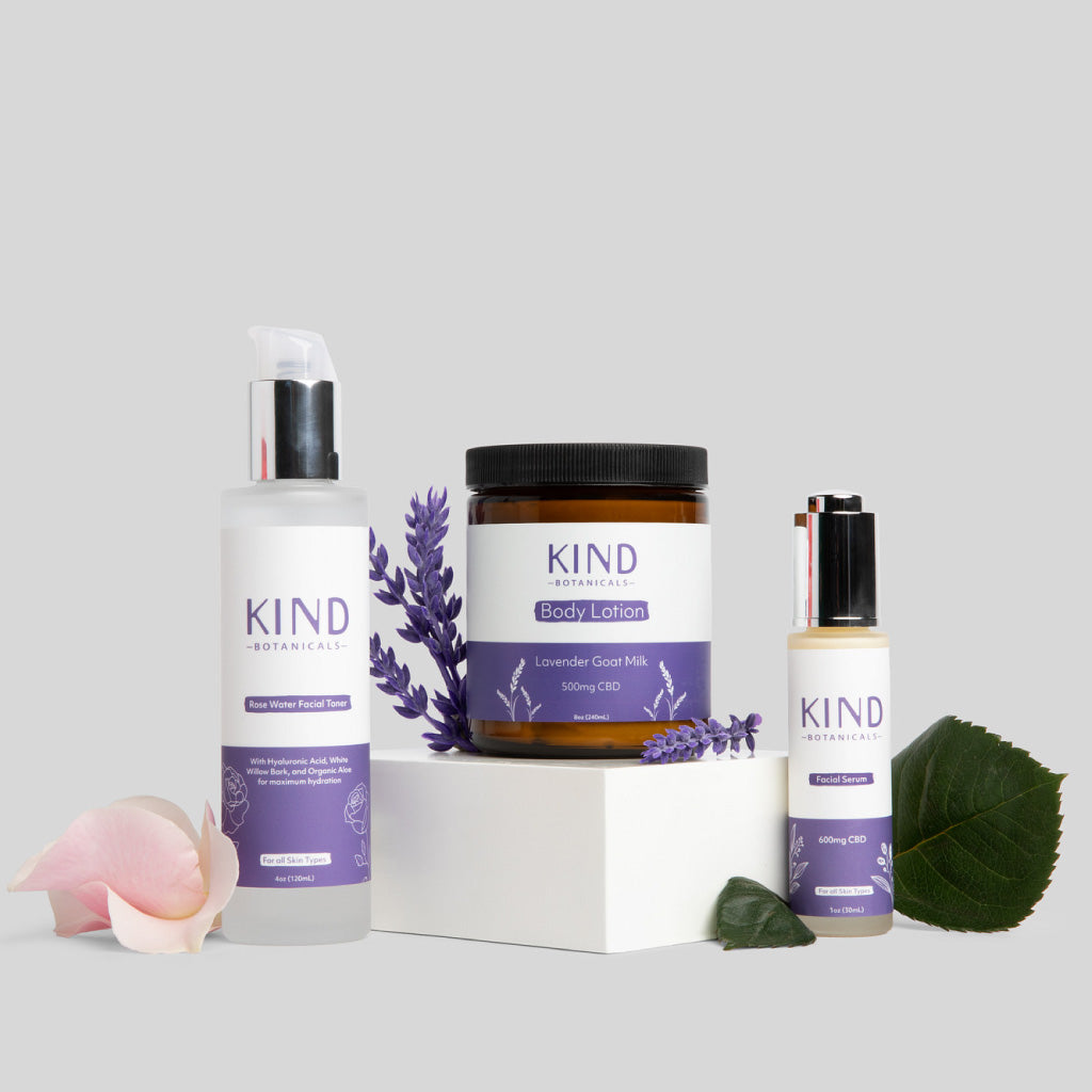 Kind Botanicals skincare products with lavender on a light gray background