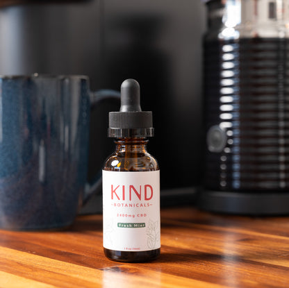 Kind CBD mint Tinctures on coffee table