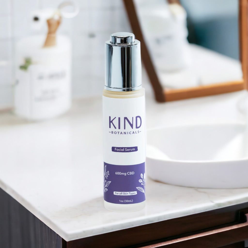 Bottle of KIND Botanicals facial serum on a bathroom counter