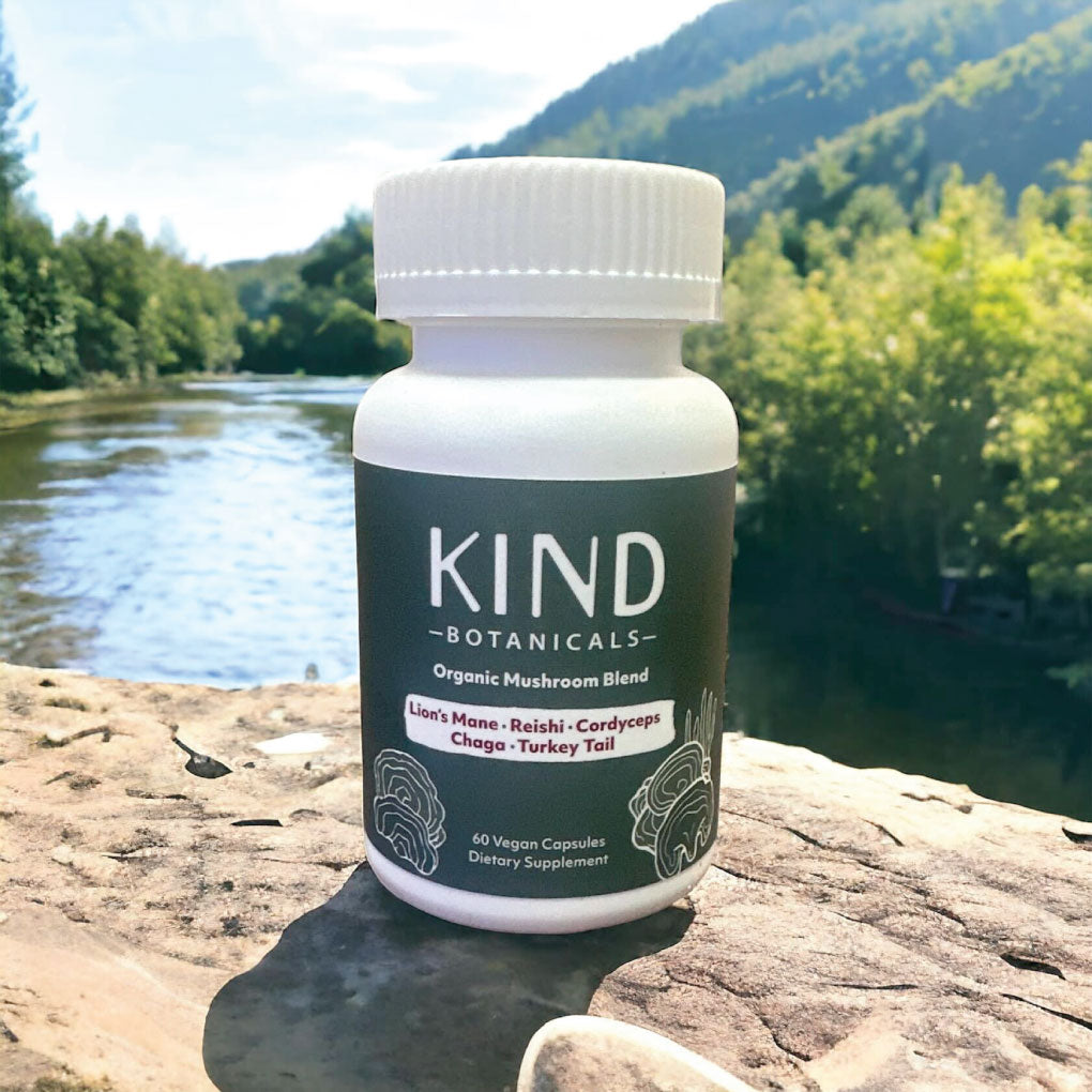 Mushroom Blend bottle on a rock by a river